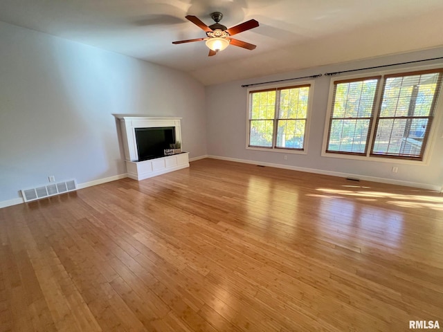 unfurnished living room with lofted ceiling, light hardwood / wood-style flooring, and ceiling fan