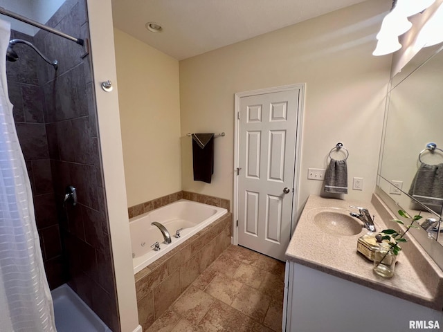 bathroom featuring vanity and independent shower and bath