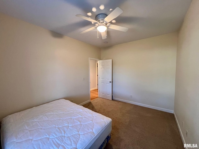 unfurnished bedroom with ceiling fan and carpet flooring