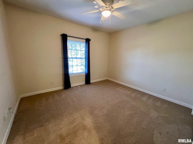 carpeted empty room featuring ceiling fan