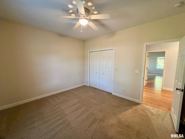 unfurnished bedroom featuring a closet, carpet flooring, and ceiling fan