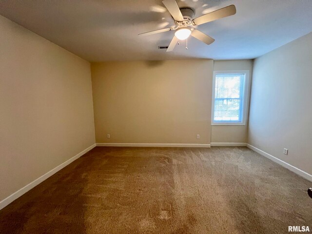 empty room featuring carpet and ceiling fan