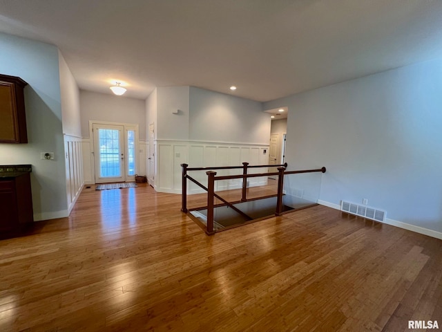 interior space featuring french doors and light hardwood / wood-style floors