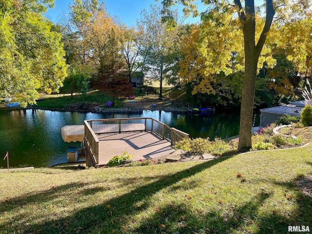 exterior space featuring a lawn and a water view