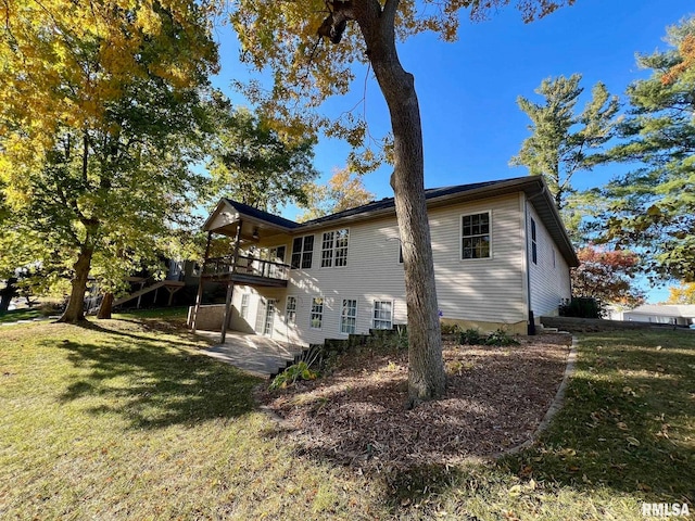 view of home's exterior featuring a deck and a lawn