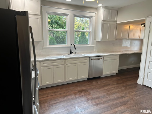 kitchen featuring dark hardwood / wood-style floors, stainless steel appliances, sink, light stone counters, and tasteful backsplash