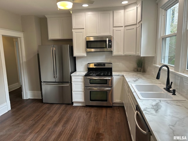 kitchen featuring sink, dark wood-type flooring, white cabinetry, and stainless steel appliances