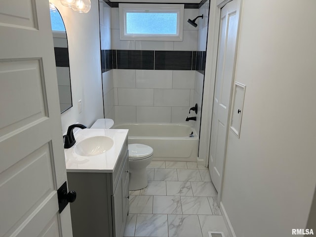 full bathroom with vanity, toilet, and tiled shower / bath combo