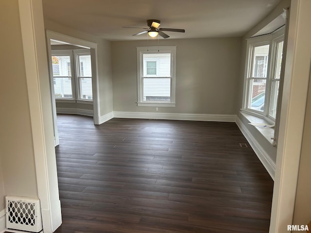 spare room with ceiling fan and dark hardwood / wood-style flooring