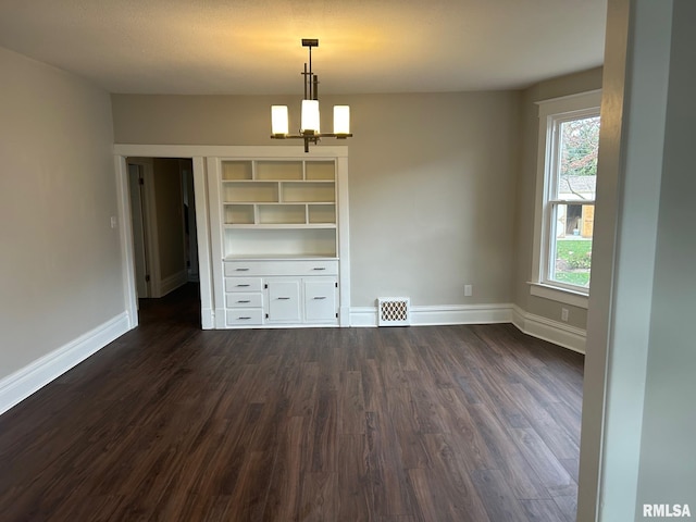 interior space featuring a notable chandelier and dark hardwood / wood-style flooring