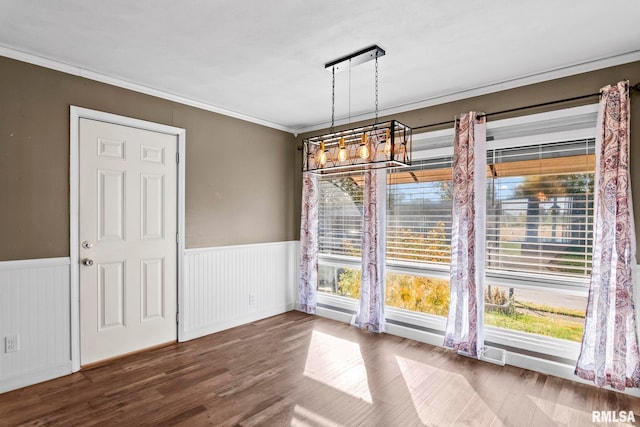 unfurnished dining area featuring ornamental molding and wood-type flooring