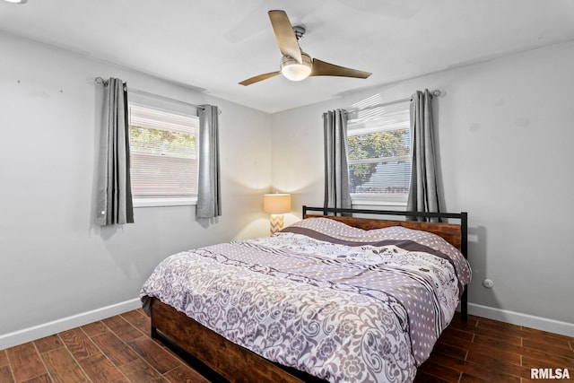 bedroom with dark wood-type flooring and ceiling fan