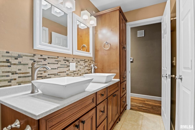 bathroom featuring vanity, tasteful backsplash, and tile patterned floors