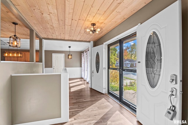 entryway with a chandelier, wood ceiling, and hardwood / wood-style flooring