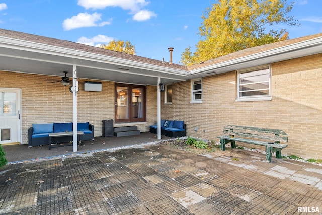 entrance to property with a patio area, an outdoor hangout area, and ceiling fan