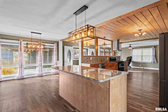 kitchen featuring plenty of natural light, hanging light fixtures, stainless steel appliances, and wooden ceiling