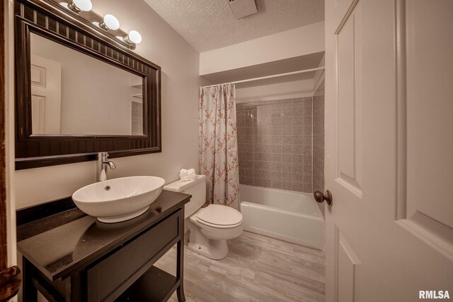 77 Country Pl Unit 77, Springfield, IL 62703 - full bathroom featuring vanity, wood finished floors, shower / bathtub combination with curtain, and a textured ceiling