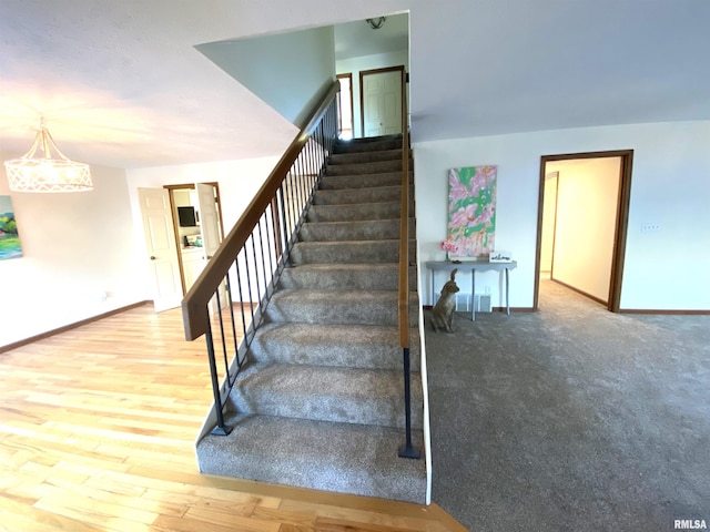 77 Country Pl Unit 77, Springfield, IL 62703 - stairway featuring wood finished floors and a chandelier