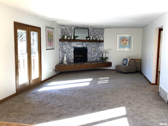 77 Country Pl Unit 77, Springfield, IL 62703 - unfurnished living room with a fireplace, carpet, and a textured ceiling