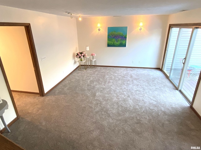77 Country Pl Unit 77, Springfield, IL 62703 - carpeted empty room with baseboards and rail lighting