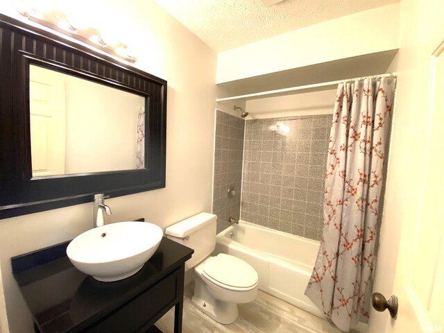 77 Country Pl Unit 77, Springfield, IL 62703 - full bath with shower / bathtub combination with curtain, vanity, a textured ceiling, and wood finished floors