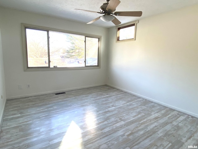 77 Country Pl Unit 77, Springfield, IL 62703 - unfurnished room with wood finished floors, a ceiling fan, and a textured ceiling