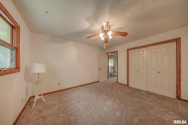 77 Country Pl Unit 77, Springfield, IL 62703 - unfurnished bedroom featuring carpet floors, a textured ceiling, a closet, and ceiling fan