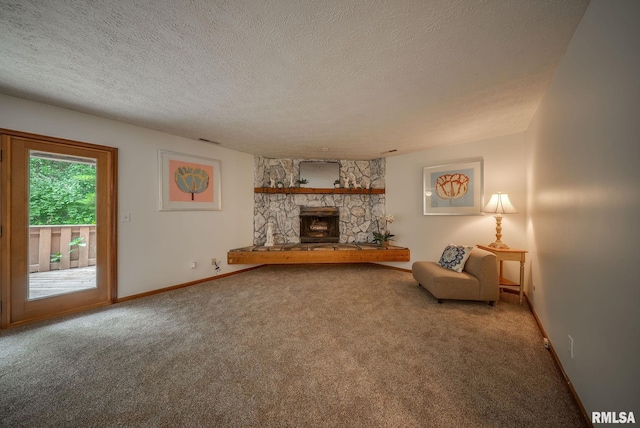 77 Country Pl Unit 77, Springfield, IL 62703 - carpeted living room with a textured ceiling and a fireplace