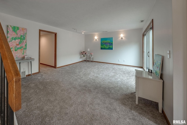 77 Country Pl Unit 77, Springfield, IL 62703 - unfurnished living room with carpet flooring and rail lighting