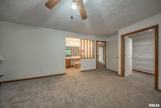 77 Country Pl Unit 77, Springfield, IL 62703 - unfurnished bedroom with carpet, a textured ceiling, ceiling fan, and connected bathroom