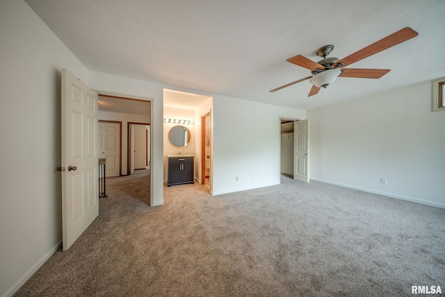 77 Country Pl Unit 77, Springfield, IL 62703 - unfurnished bedroom featuring light carpet, a textured ceiling, connected bathroom, and a ceiling fan