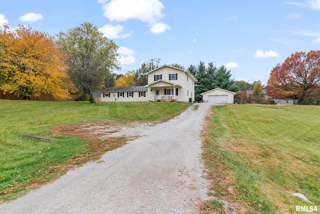 view of front of house with a front yard, covered porch, an outdoor structure, and a garage