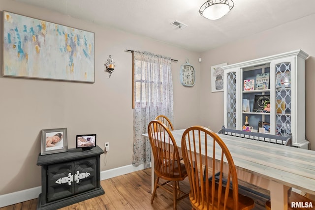 dining space with hardwood / wood-style floors