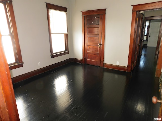 spare room with dark hardwood / wood-style floors