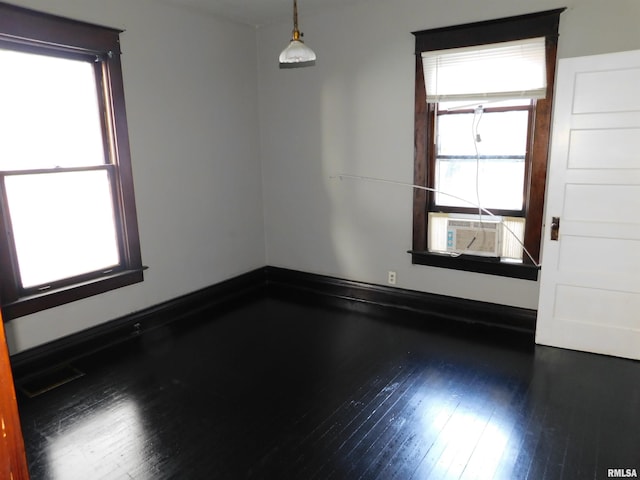 empty room featuring dark hardwood / wood-style flooring