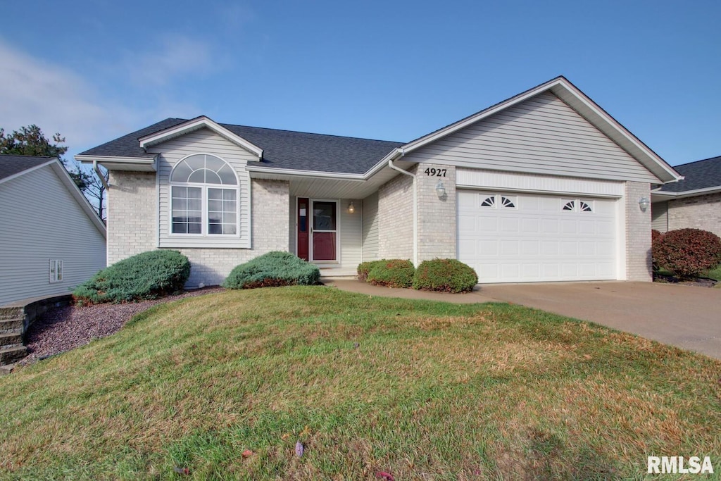 single story home with a front yard and a garage