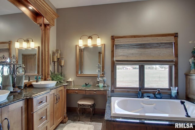 bathroom with vanity and a washtub