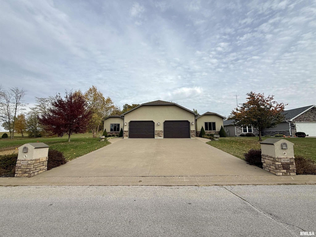 view of front facade featuring a garage and a front lawn