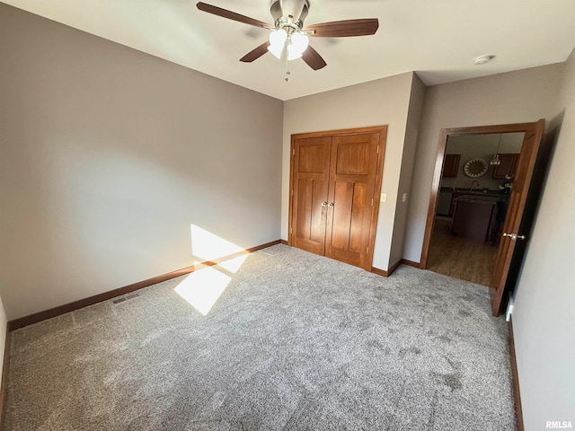 unfurnished bedroom with carpet, a closet, and ceiling fan