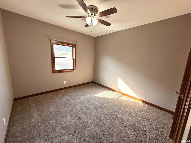 carpeted spare room with ceiling fan