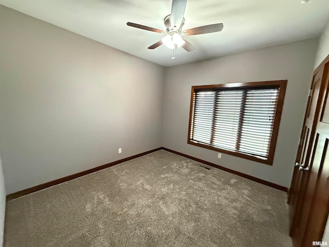 empty room with carpet flooring and ceiling fan