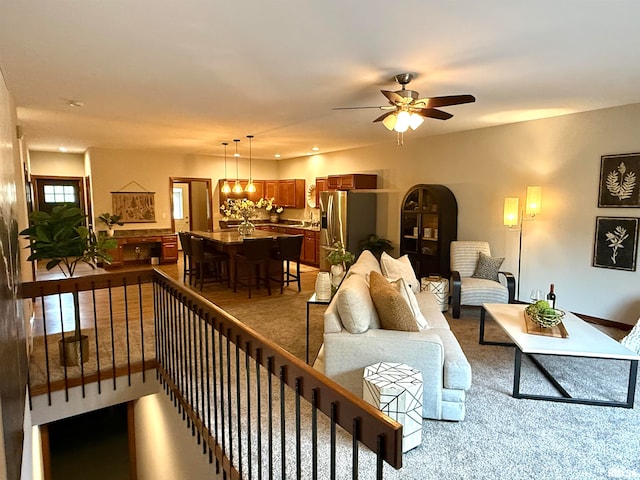 living room with light carpet and ceiling fan