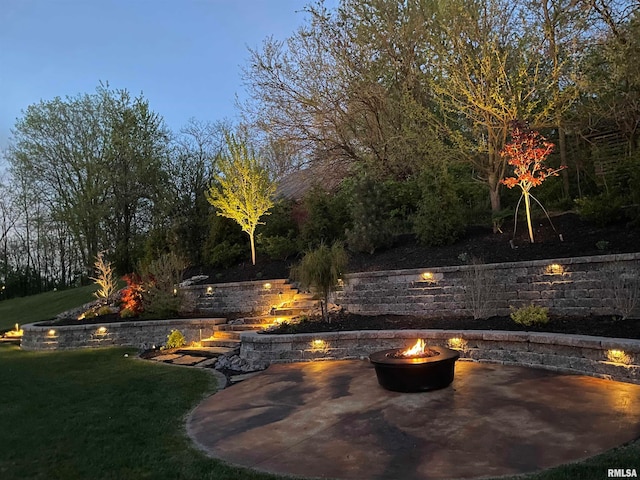 exterior space featuring a patio and a fire pit