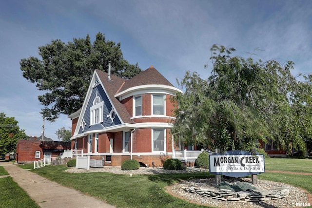 view of front facade featuring central AC and a front yard