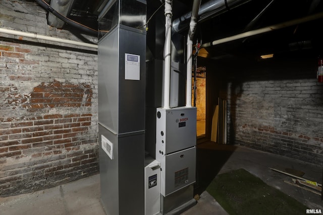 utility room featuring heating unit