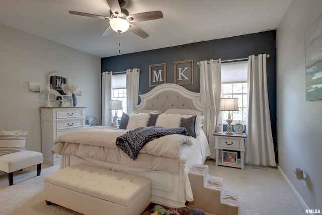 bedroom featuring light carpet and ceiling fan