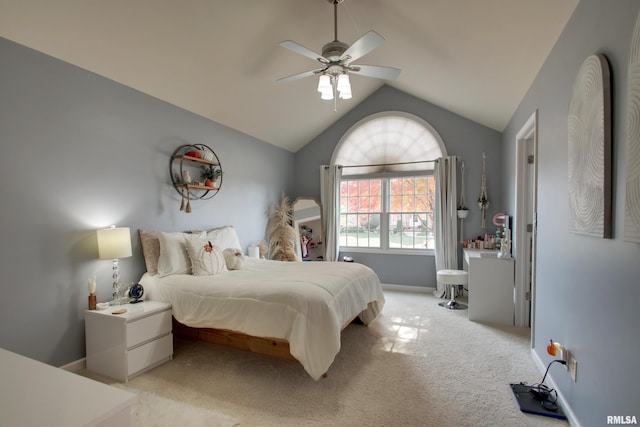 bedroom with vaulted ceiling, light colored carpet, and ceiling fan