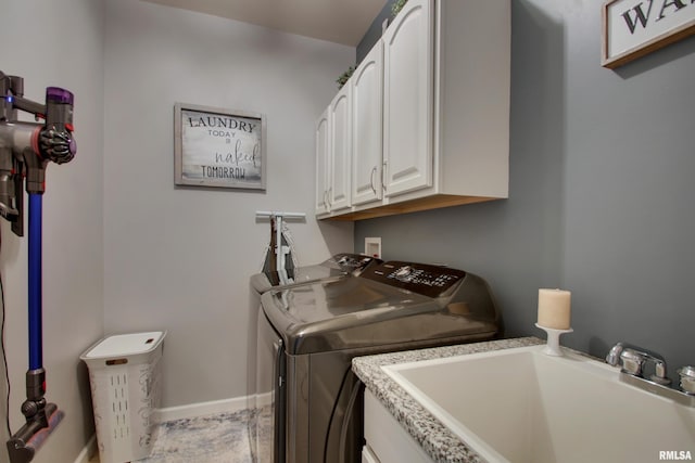 laundry area with cabinets, sink, and washing machine and clothes dryer