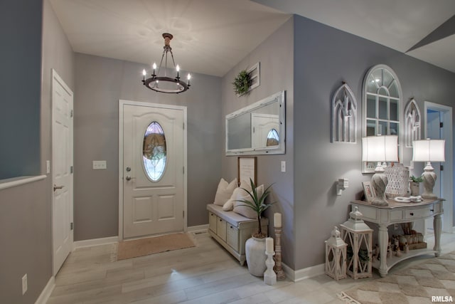 foyer featuring an inviting chandelier and light hardwood / wood-style flooring