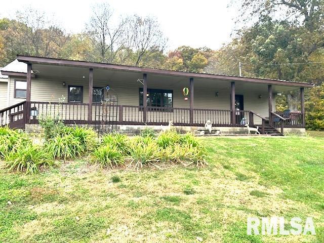 view of front of home featuring covered porch and a front yard